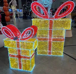 Two large light up yellow presents with red bows.