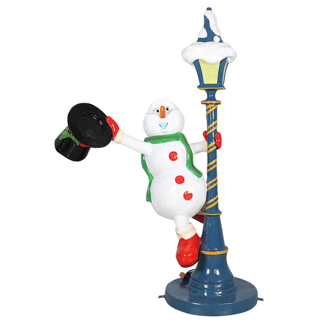 Cheerful snowman with red gloves and boots holding a black hat, leaning on a decorated blue lamppost.