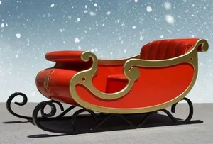 Red and gold sleigh with black runners against a snowy, starry sky background.