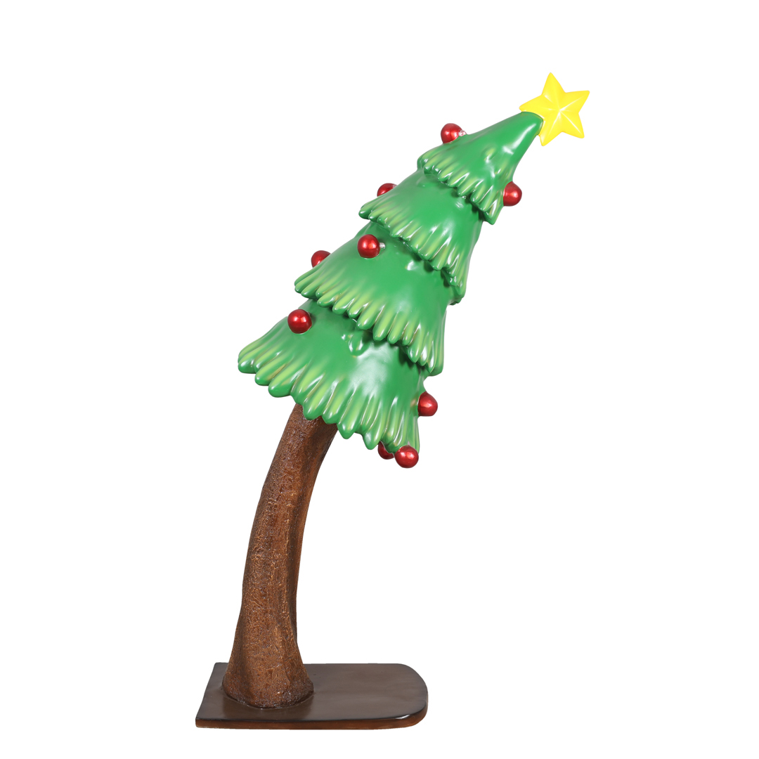 Tilted Christmas tree sculpture with a bent trunk, red ornaments, and a yellow star on top.