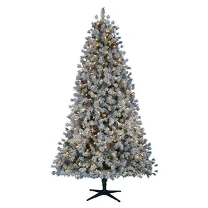 Flocked artificial Christmas tree with warm white lights on a black stand.