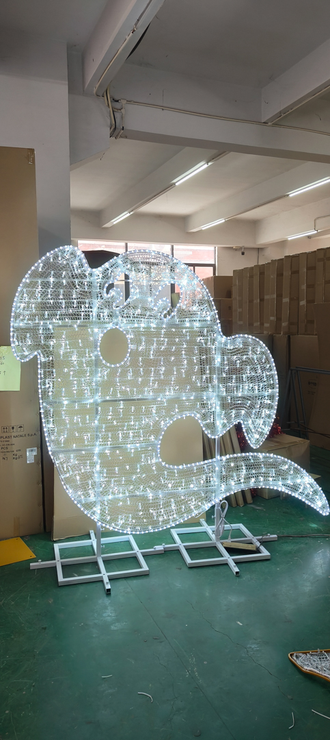 White LED light decoration shaped like a ghost inside a warehouse with stacked boxes.
