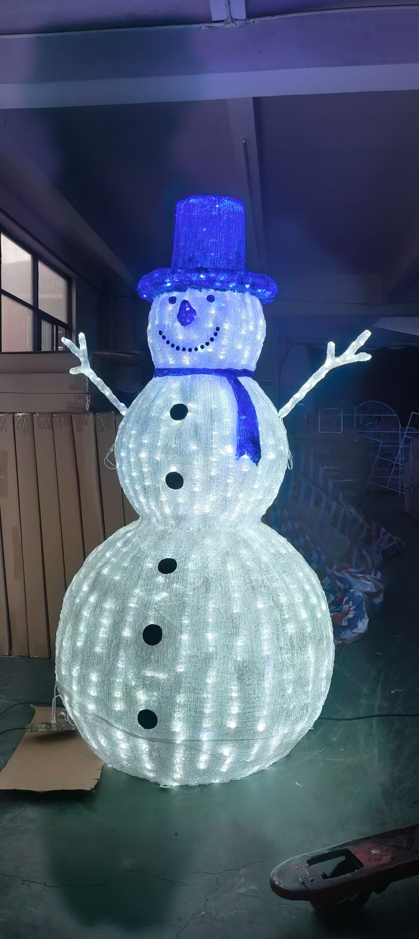 Large light-up snowman decoration with blue hat and scarf.