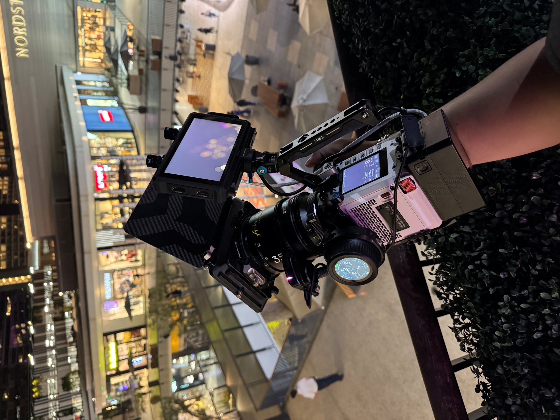 High end cinema camera rig being held in hand.