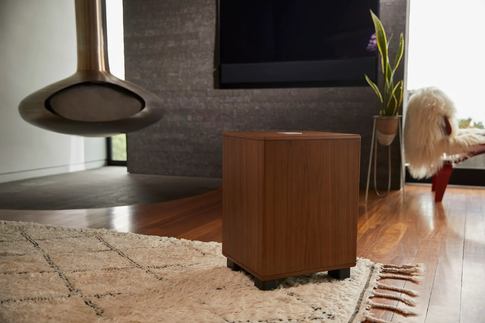 REL Classic 98 subwoofer in a walnut-furnished living room