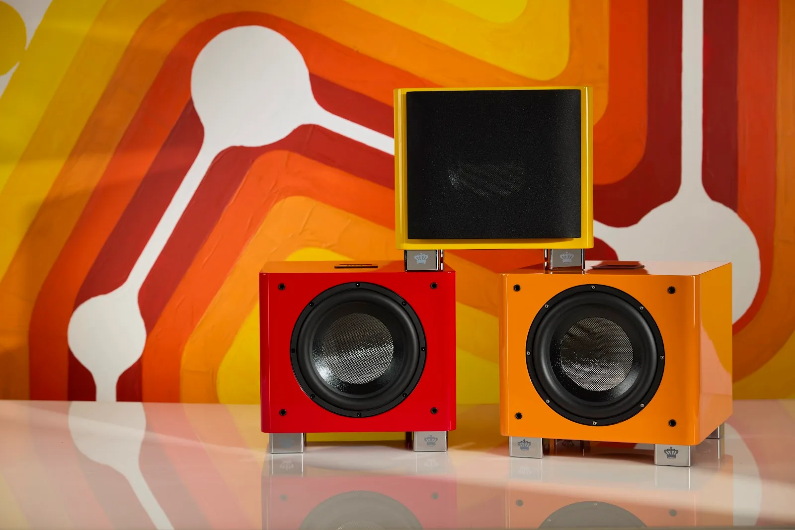 Three REL T/9x SE subwoofers together in Tangerine Dream, Italian Racing Red and Le Mon Yellow