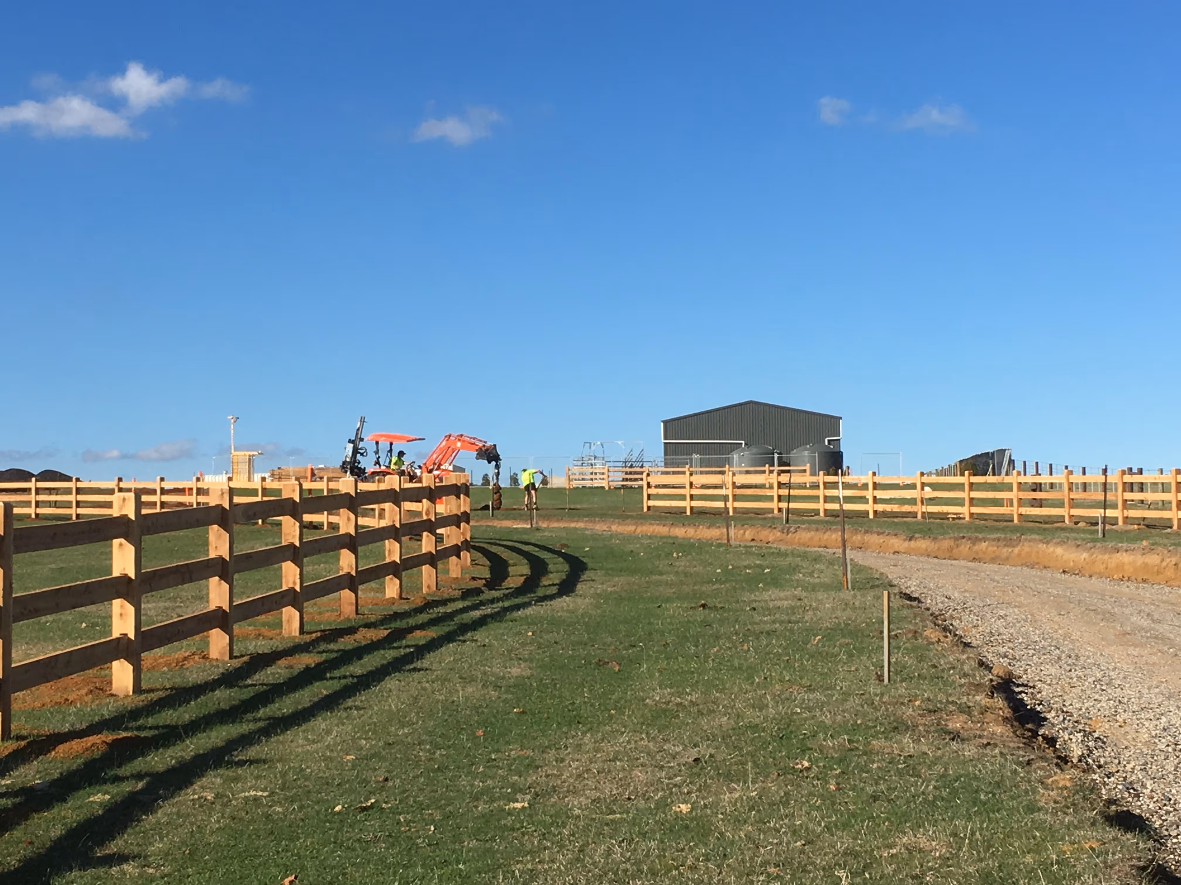 Image of a three rail cypress pine post and rail face being installed in 