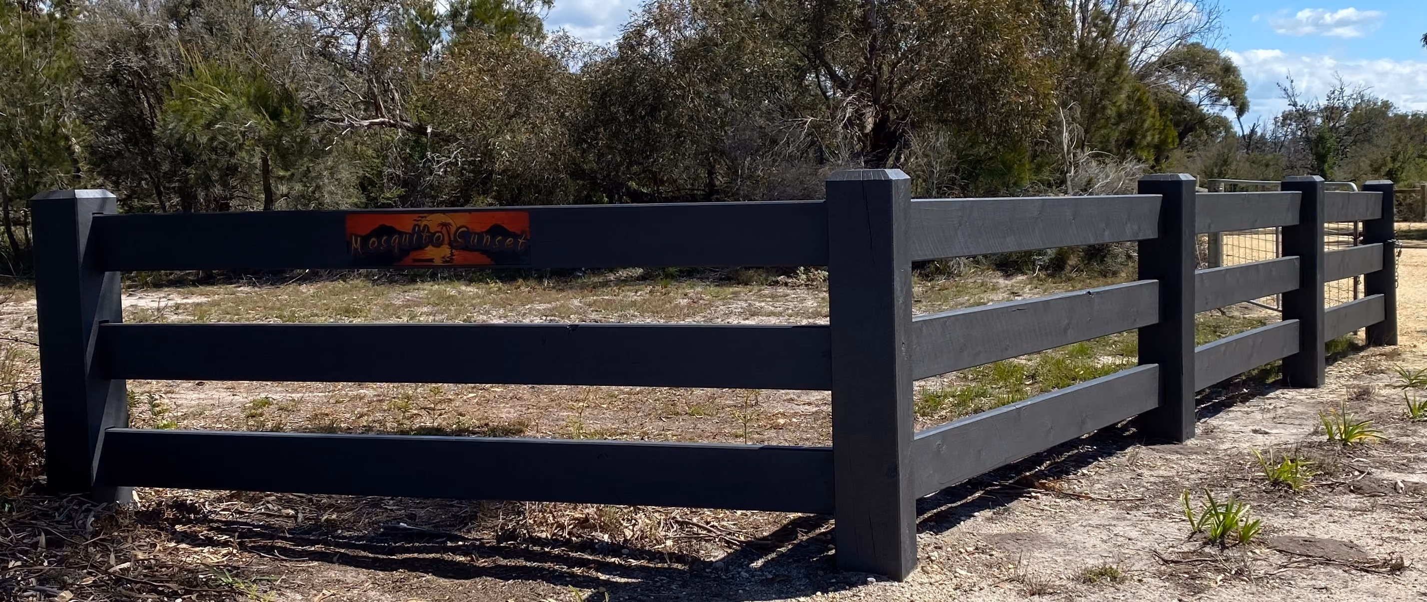 Three rail cypress post and rail fence on a rural property