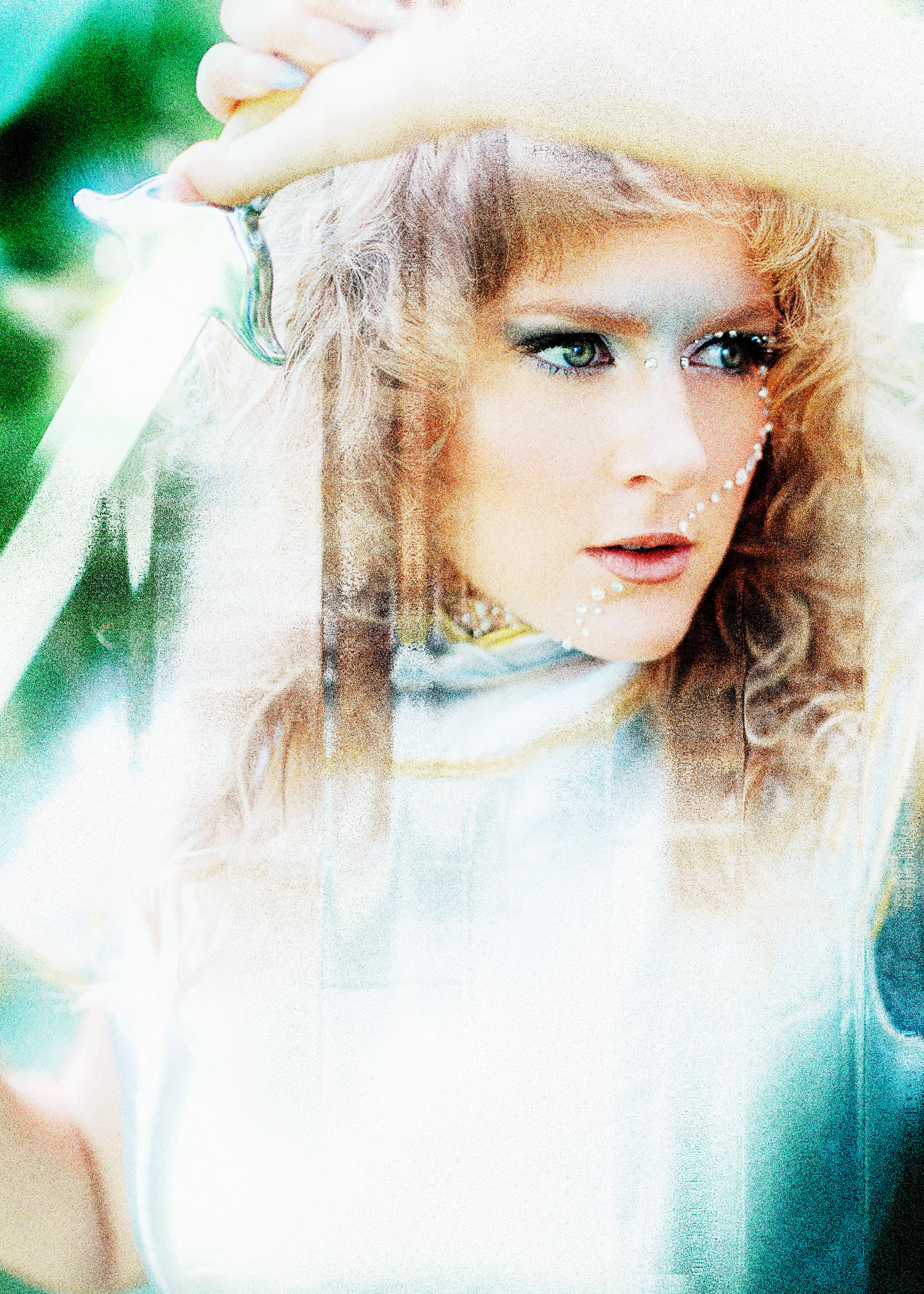 Ethereal portrait of Soraya Teschner of IONNA with pearl face jewels and a veil
