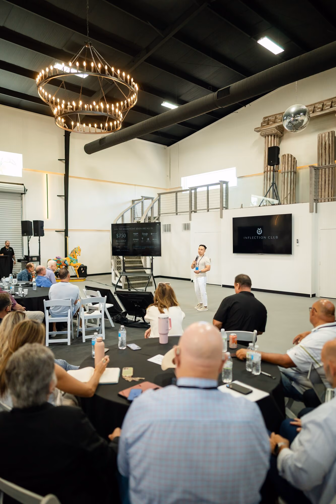 The main room during a presentation, tables arranged around the floor