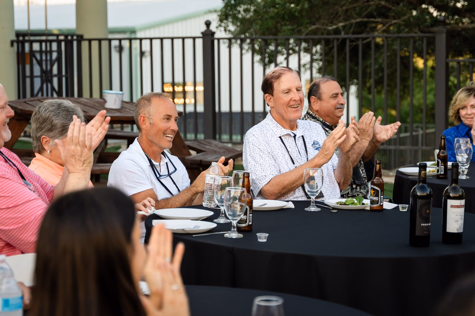 Members applauding at the dinner table