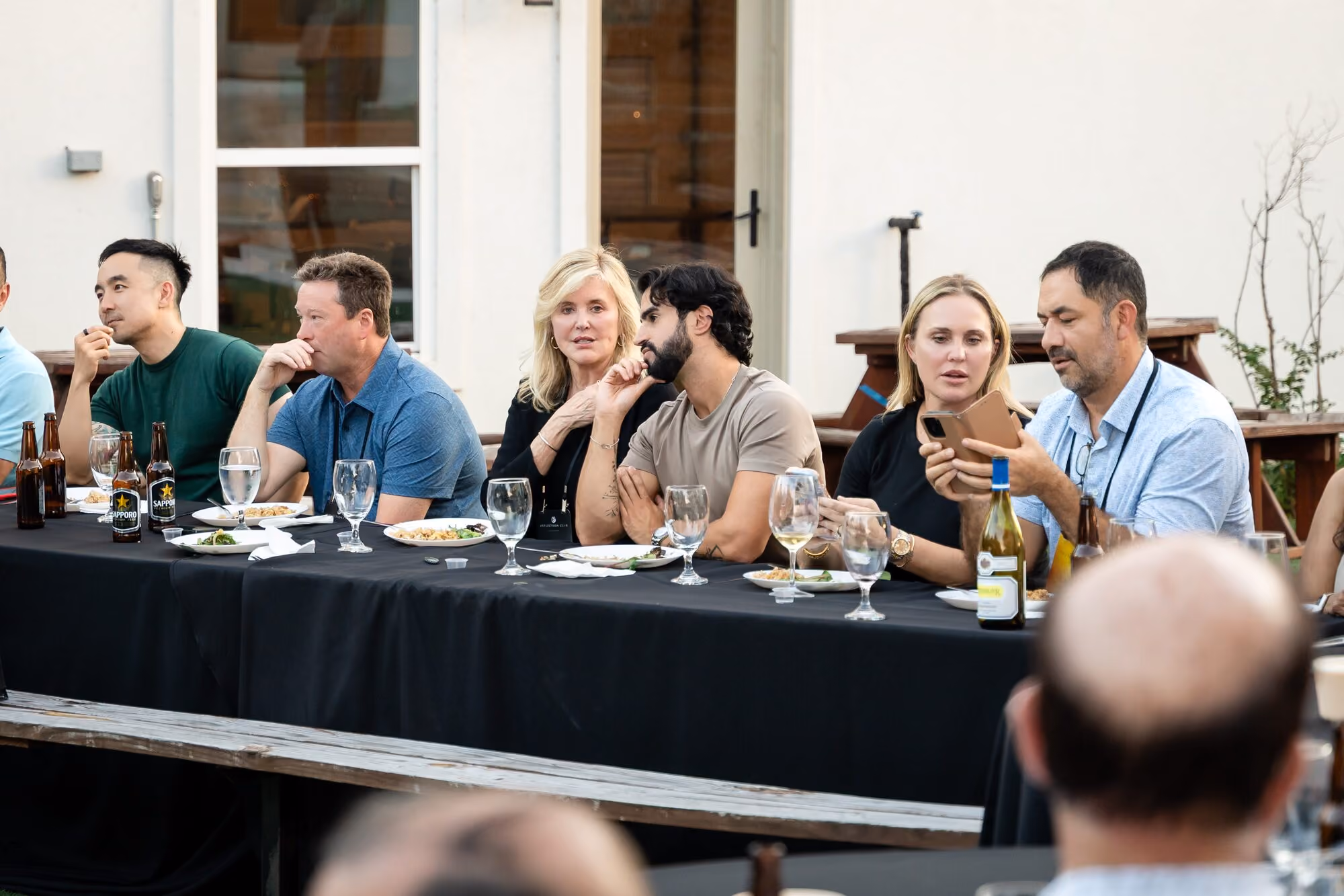 Members seated along the long table at dinner