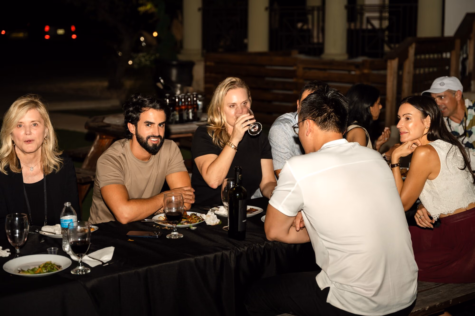Members talking over dinner after dark