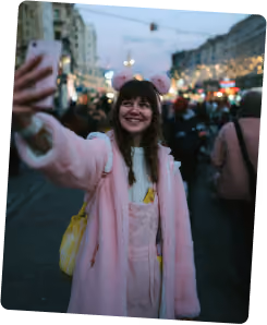 Creator in pink coat on a city street