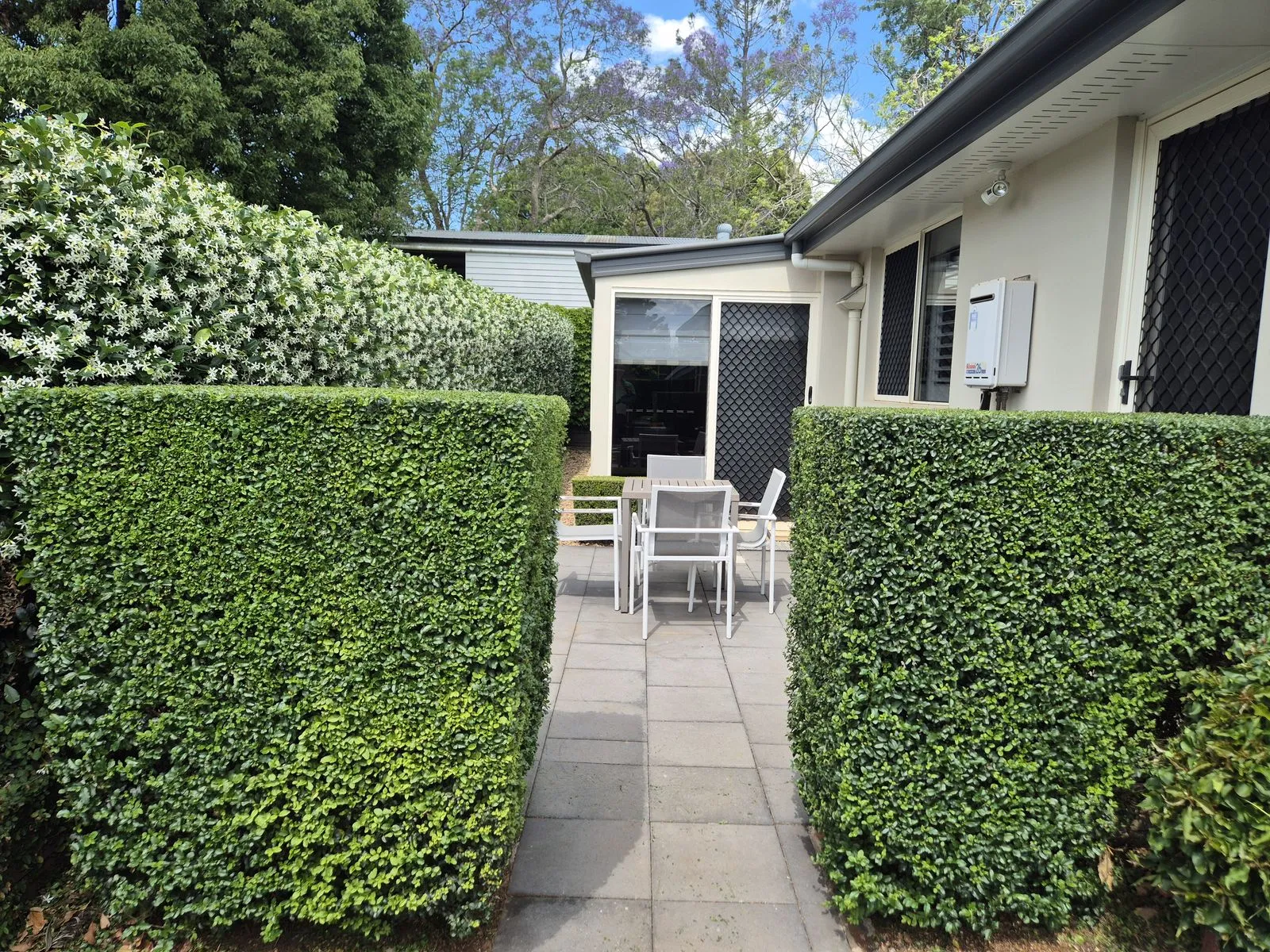 Square-cut hedges framing a courtyard path in East Toowoomba