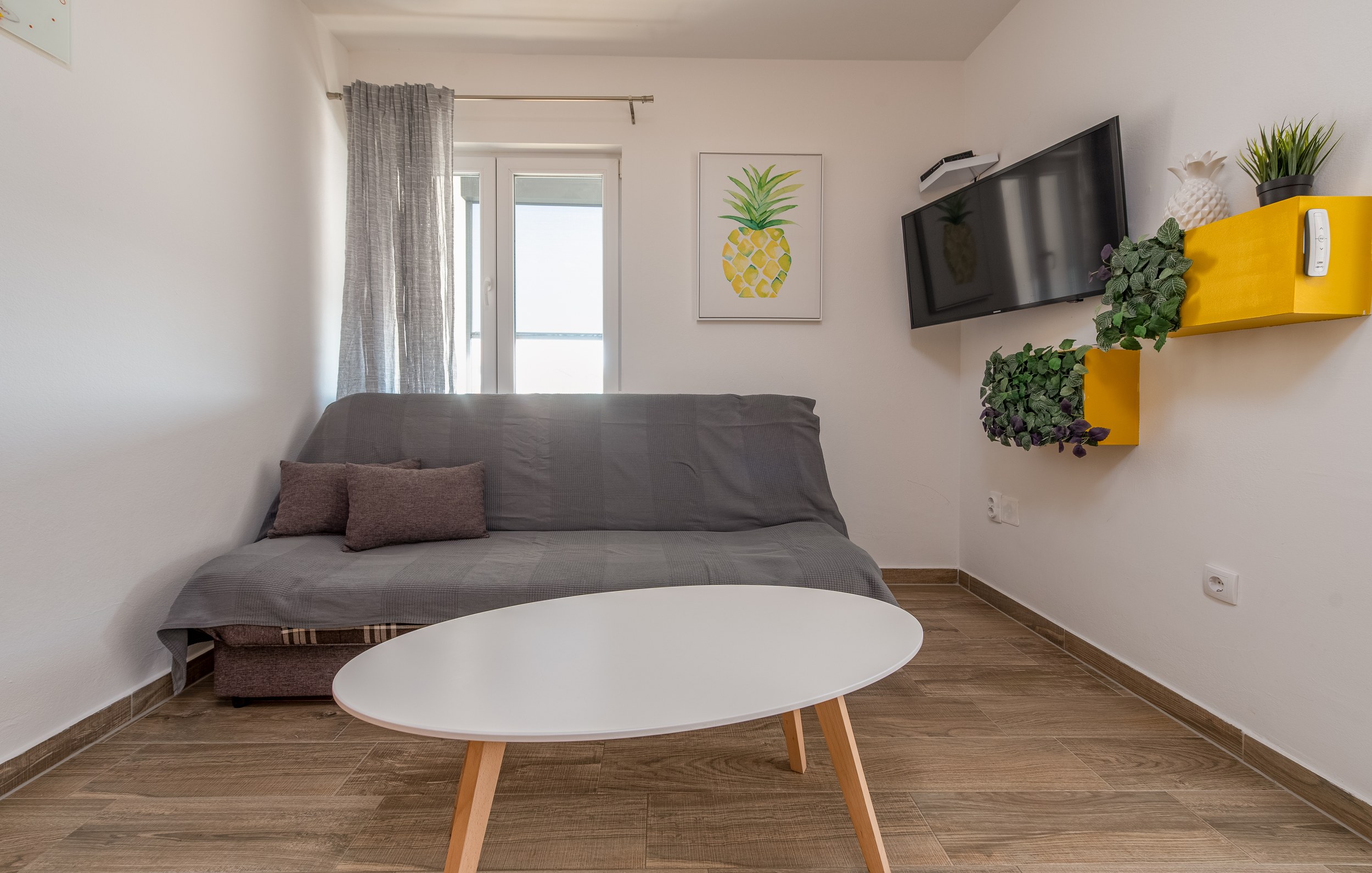 Sitting room with sofa bed and pineapple print, Apartment Yellow