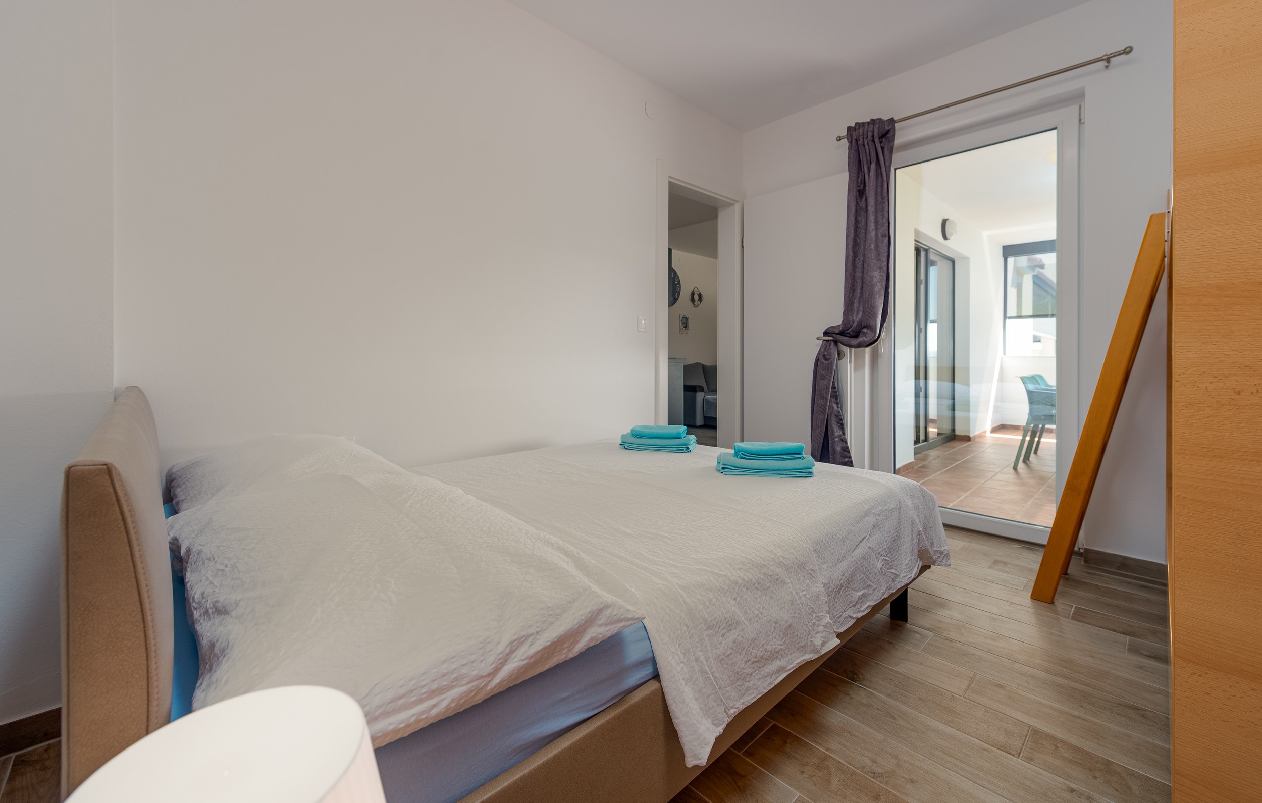 Double bed with doors to the living room and terrace, Apartment Blue
