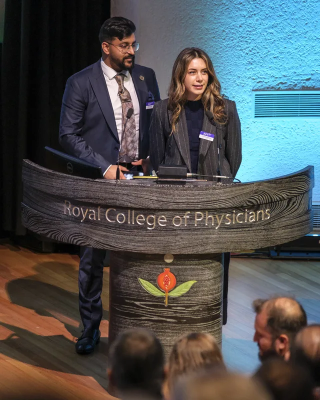 Dr Payvand Menhadji speaking at the Royal College of Physicians podium during an ADI event