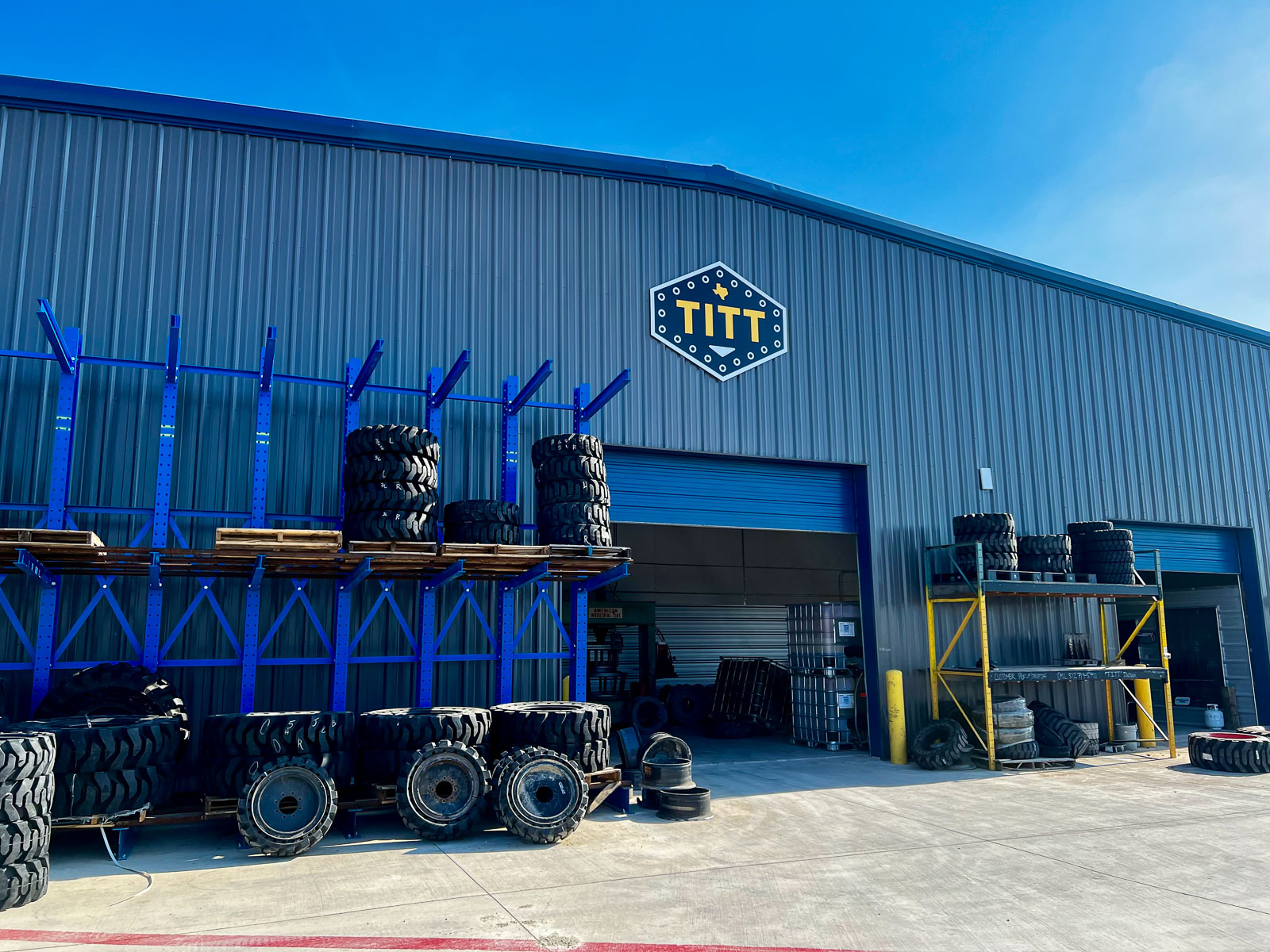 Solid tires and press-on wheels stacked at the Tru-test Industrial shop in Hutto, Texas