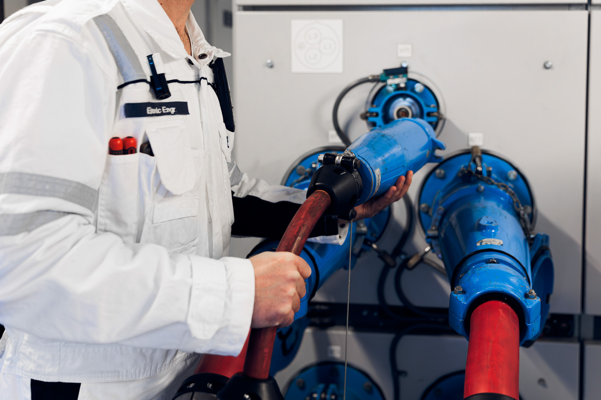 Crew member connecting the shore power cable on board a vessel.