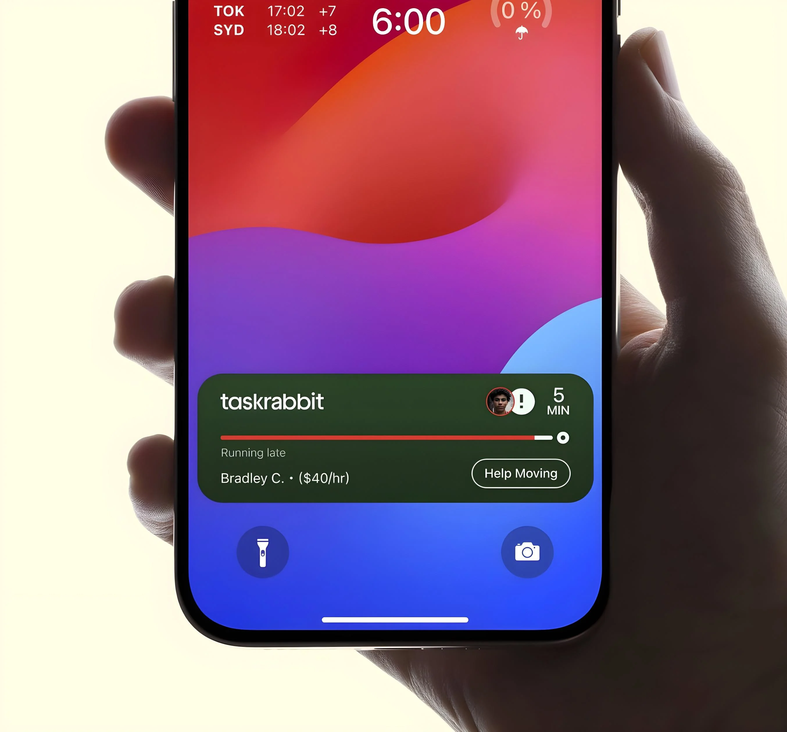 Hand holding smartphone showing taskrabbit widget with running late task by Bradley C. at $40/hr.