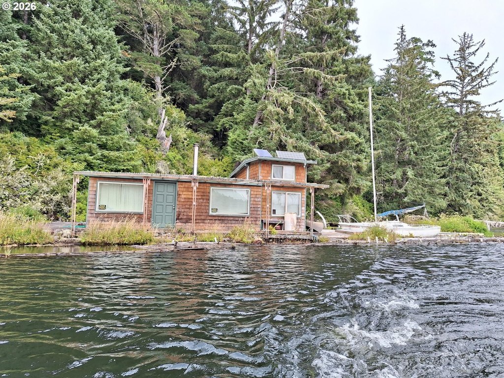 1945 Tahkenitch Lake Float House with Off-Grid Solar Setup — $99,000