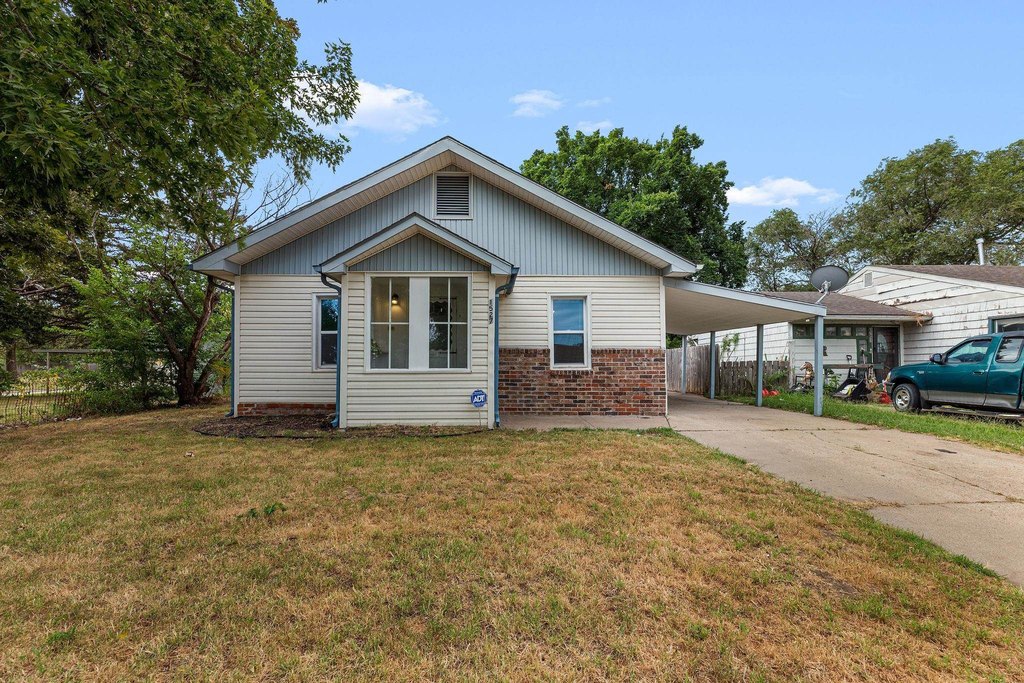1920 Hutchinson Home with Floor-to-Ceiling Stone Fireplace — $99,900