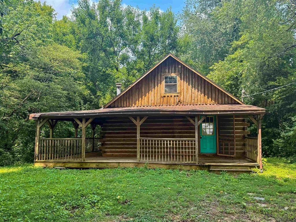 1989 Log Home on a Wooded Acre with Shop and Covered Porch — $145,000