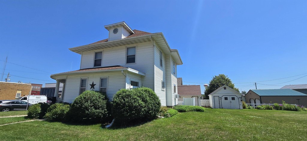 1915 New Hampton Two-Story with Original Millwork and Three-Stall Garage — $149,900