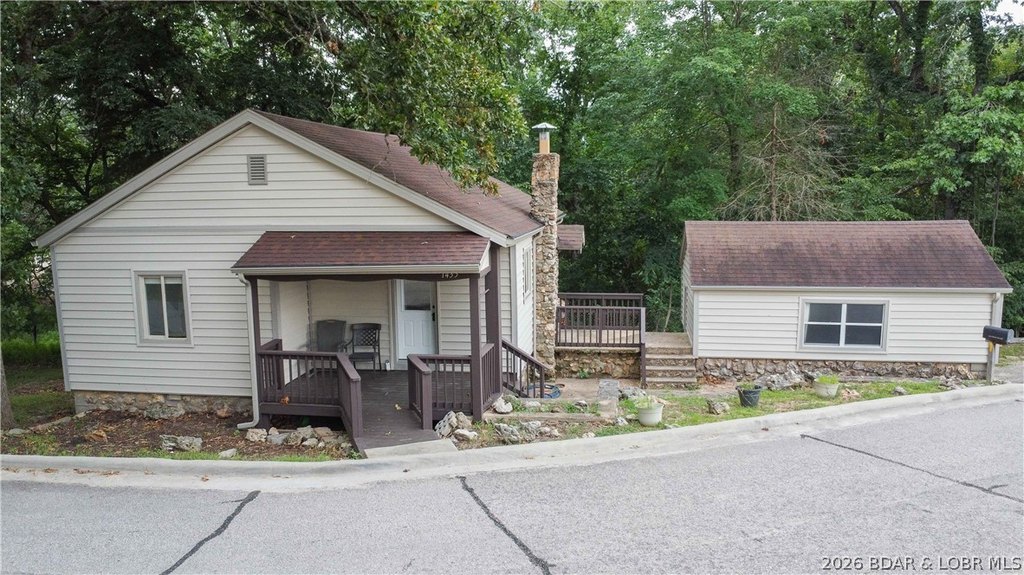 1950s Swiss Village Cabin with Lake Views, Pool Access, Boat Slip Option — $150,000