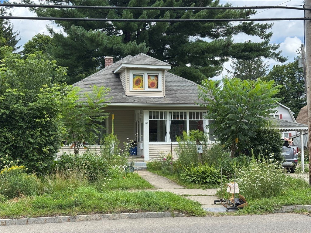 1915 Wellsville Bungalow with Oak Woodwork, Leaded Windows, and a Wild Garden — $145,000