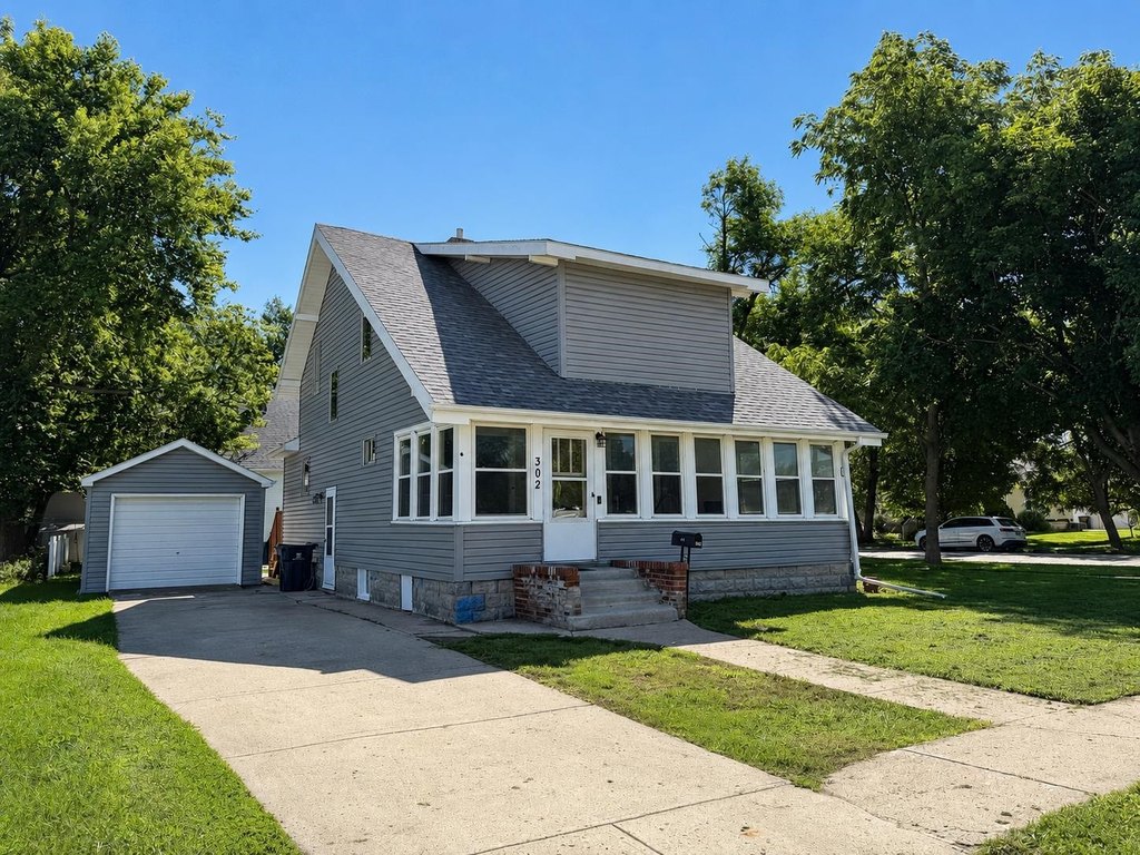 1915 Estherville Home with Built-In Buffet, Tall Ceilings, and Enclosed Porch — $124,900