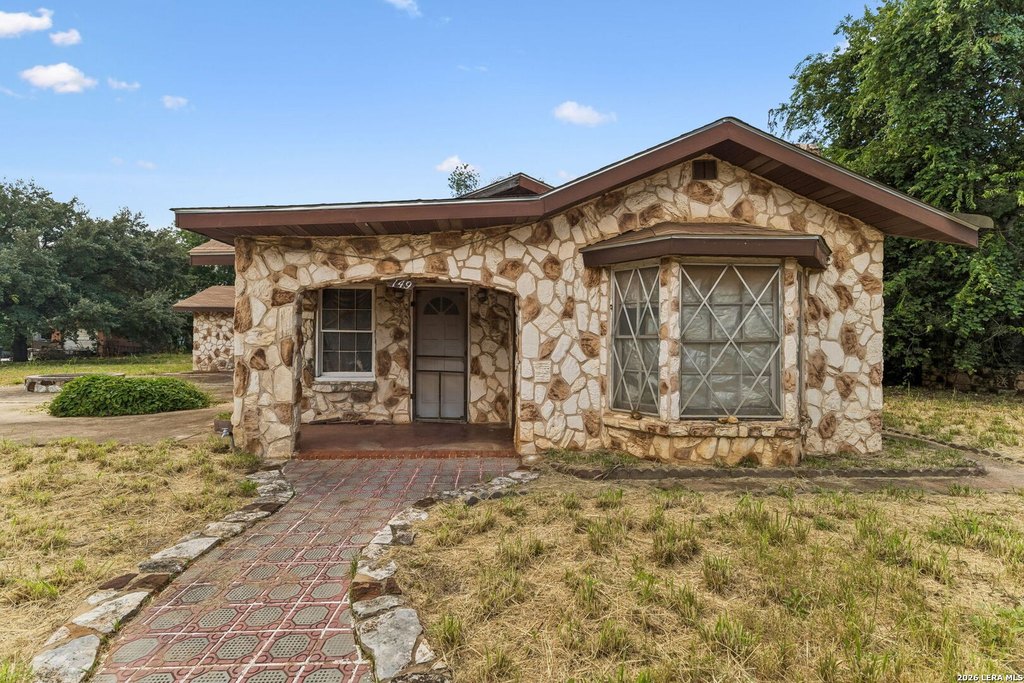 Stone Cottage with Basement, Wrap Porches, and Barn on 0.39 Acres — $64,999