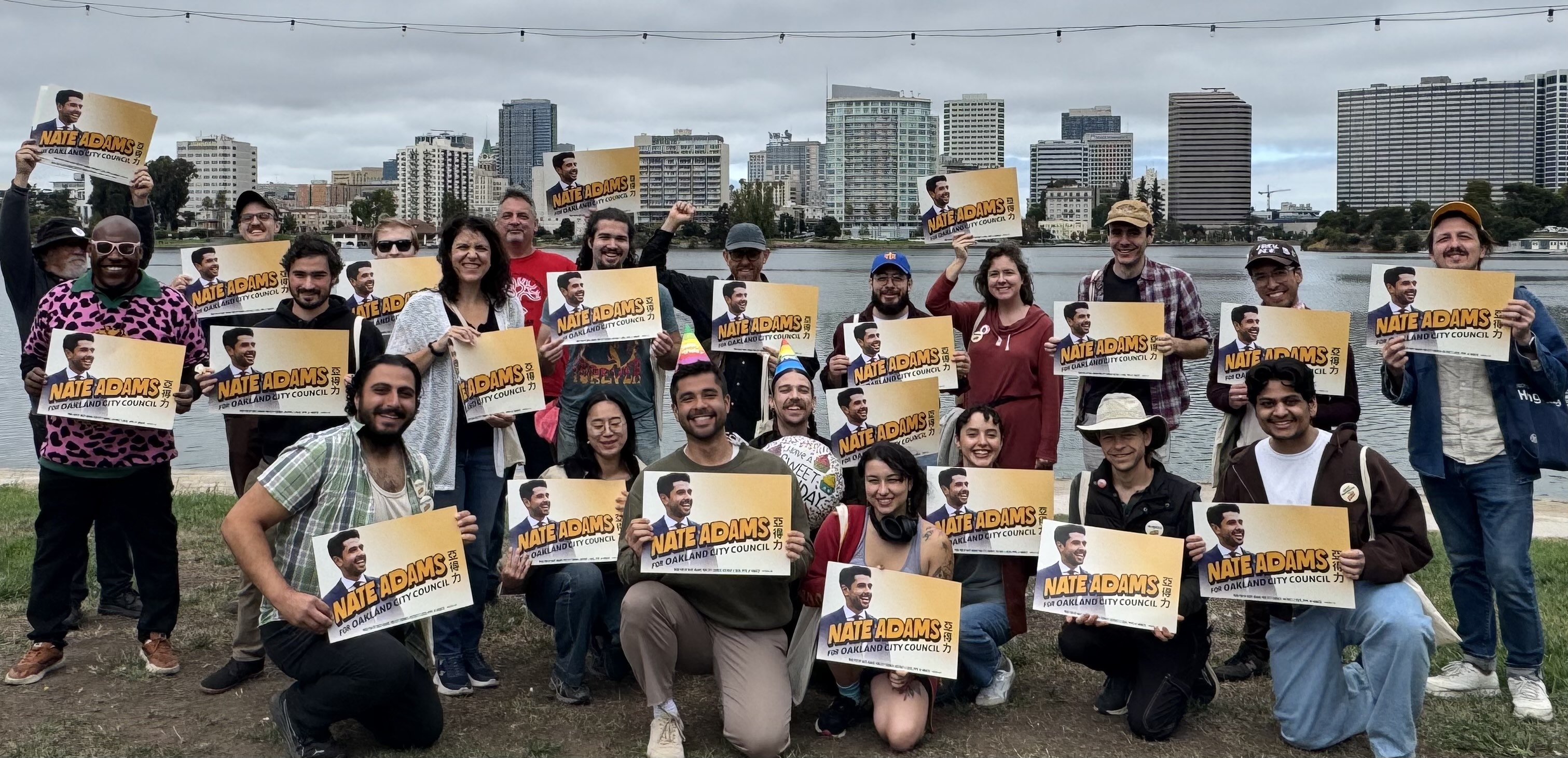 Canvassers pose for a group photo with Nate in front of Lake Merritt