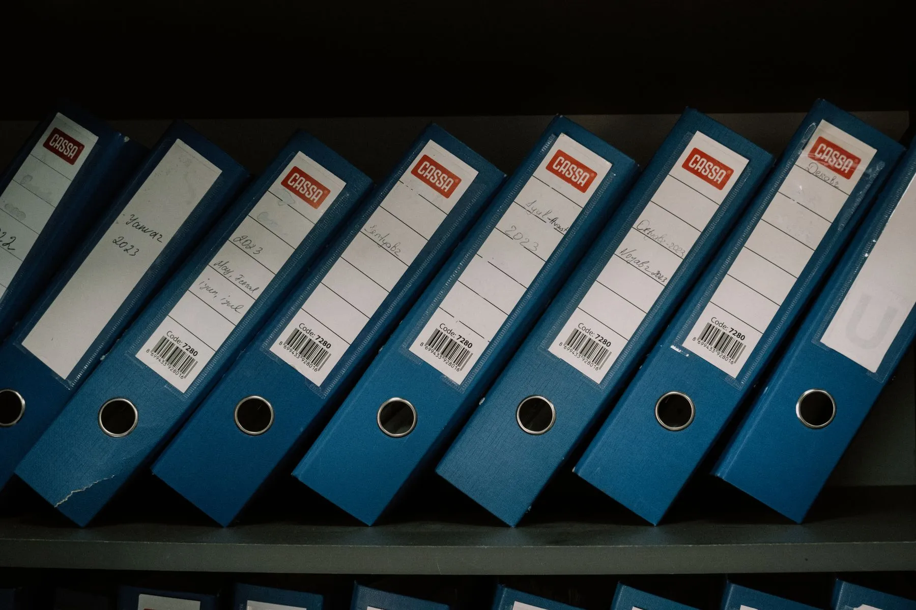 Labelled folders on an archive shelf, illustrating the documented chain of title