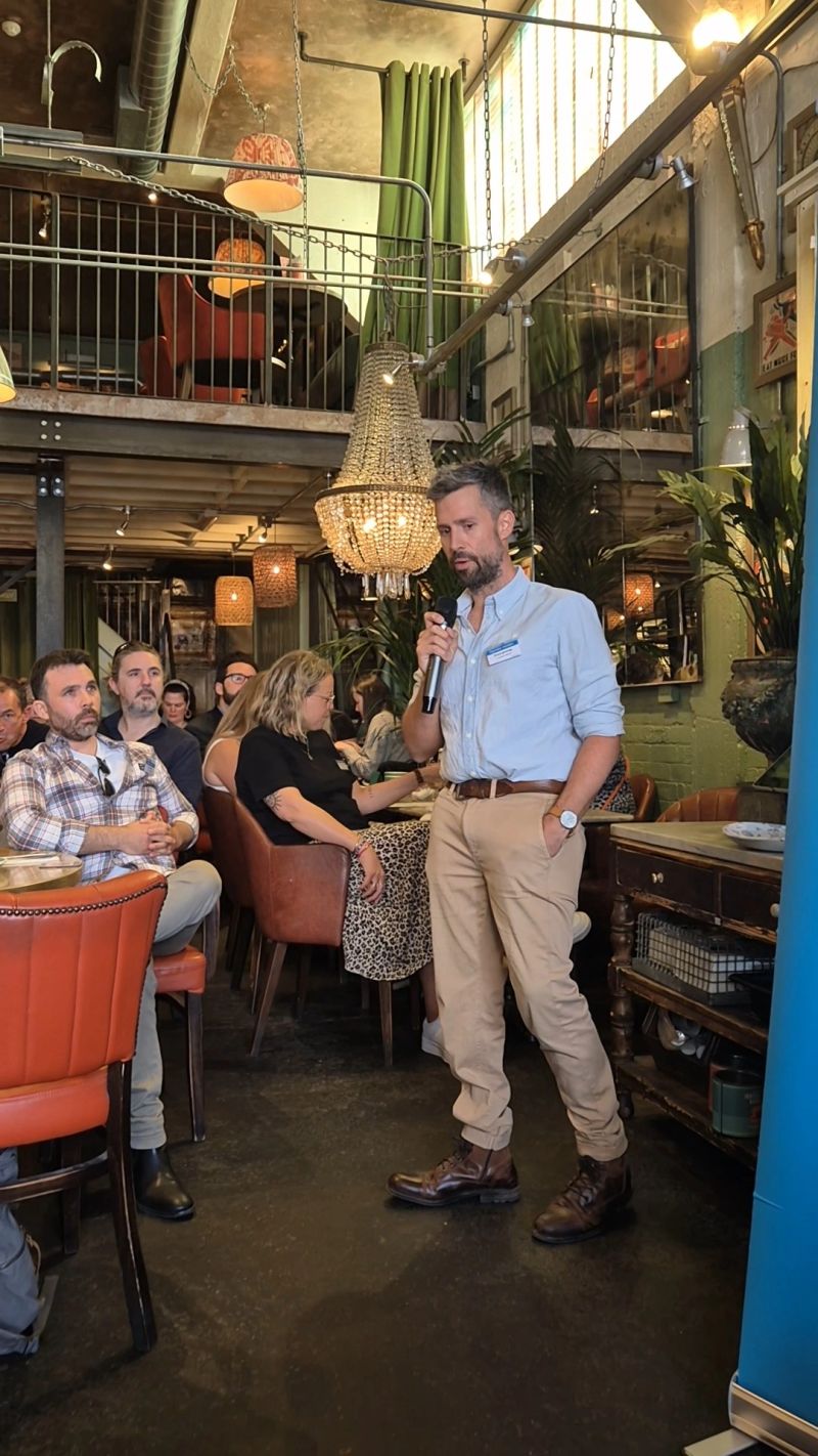 Grant Jennings giving a talk in front of an engaged audience