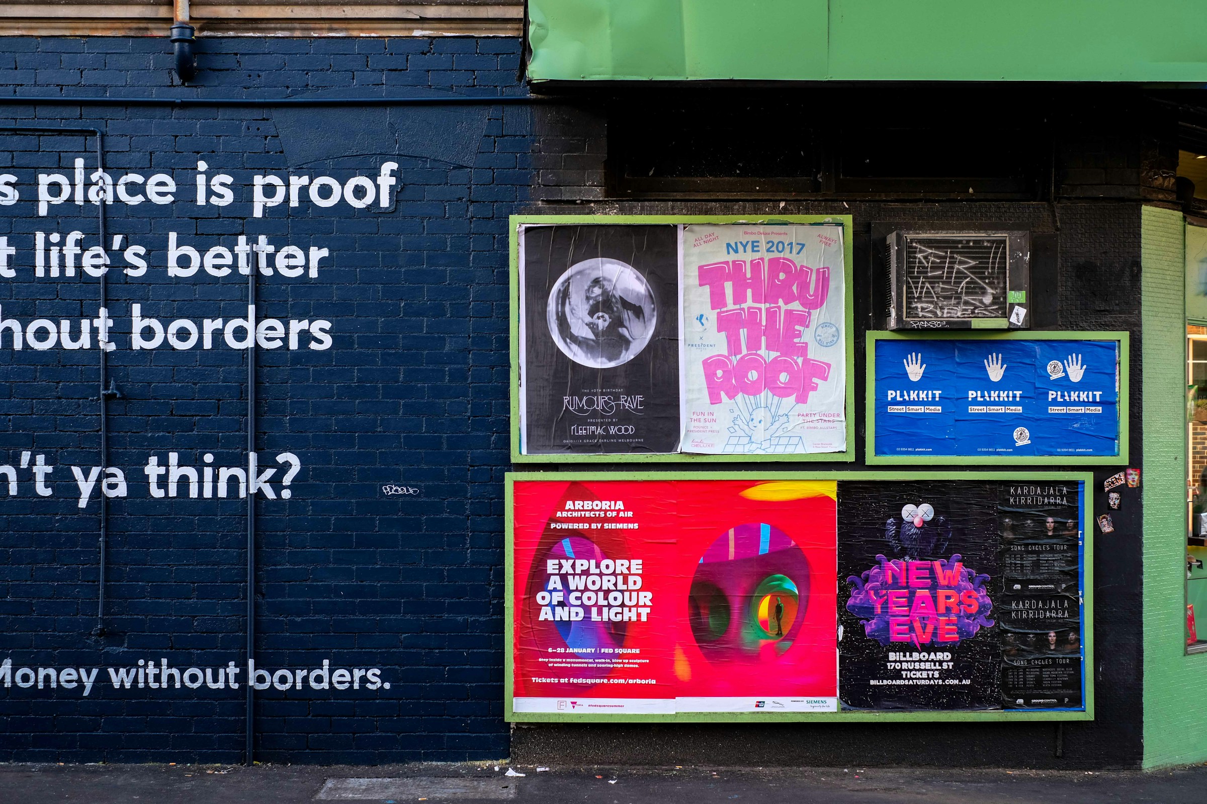 Printed posters pasted across a building wall