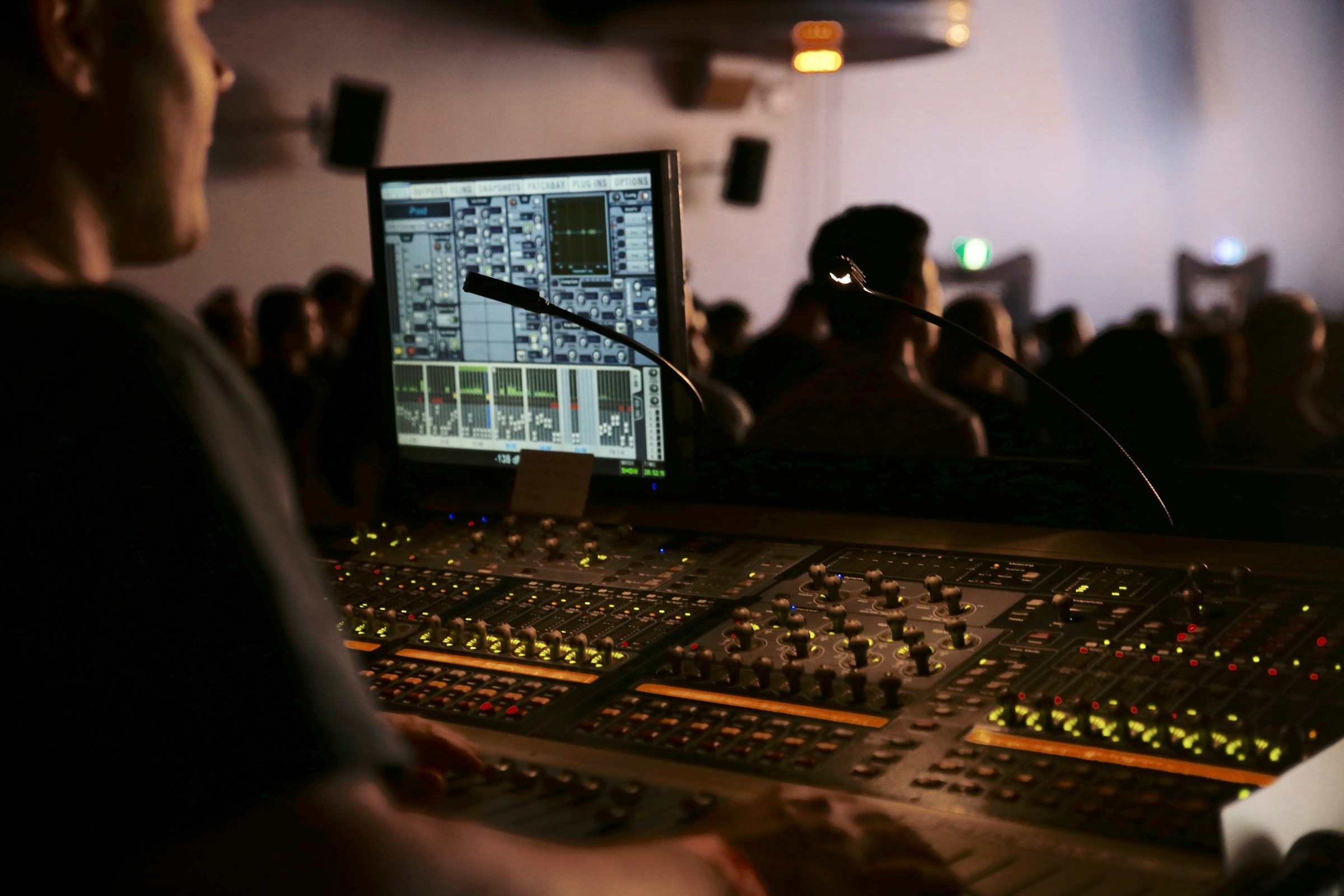 Sound engineer at a mixing console during a service