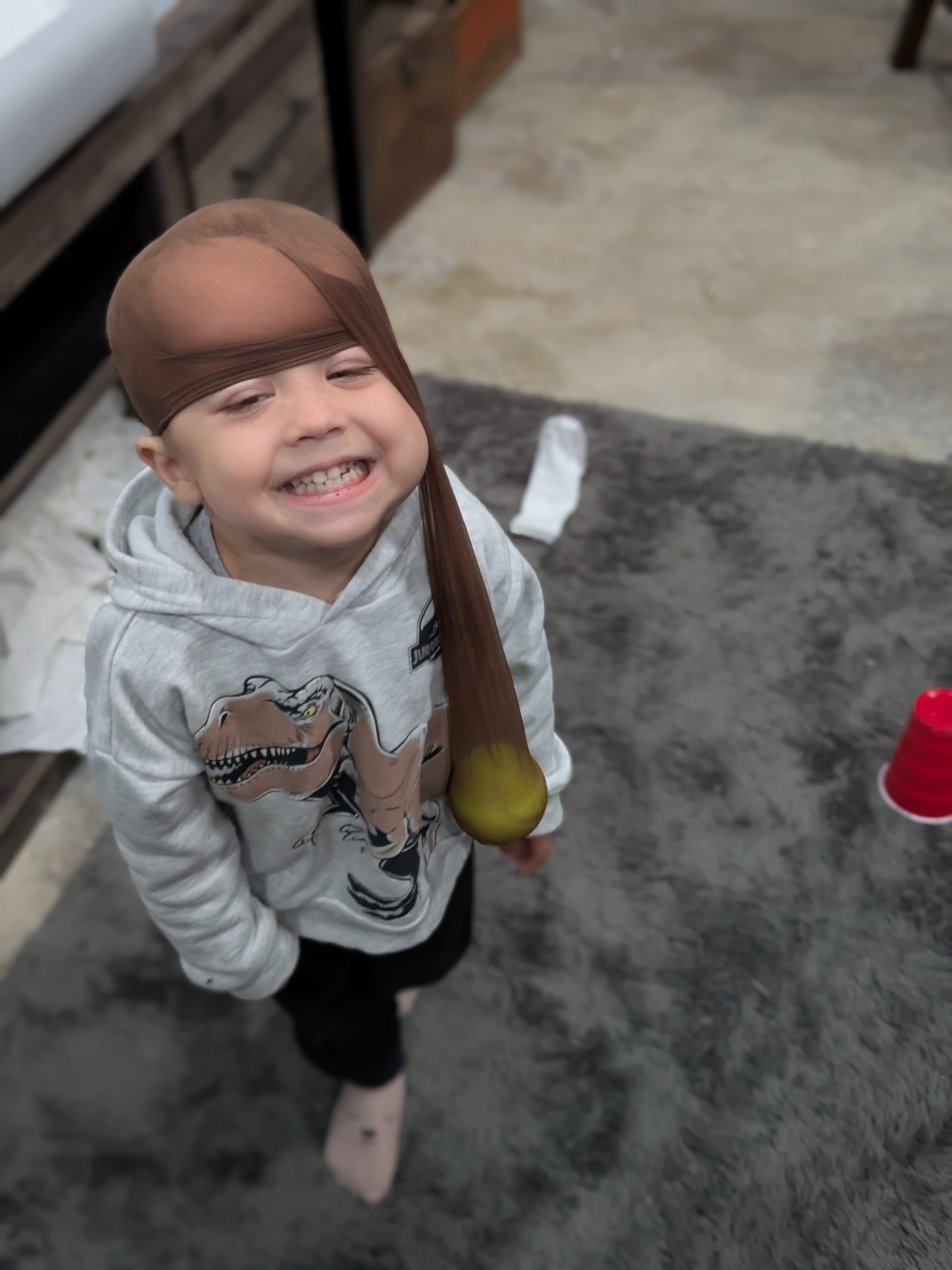 Luke smiling and playing dress-up