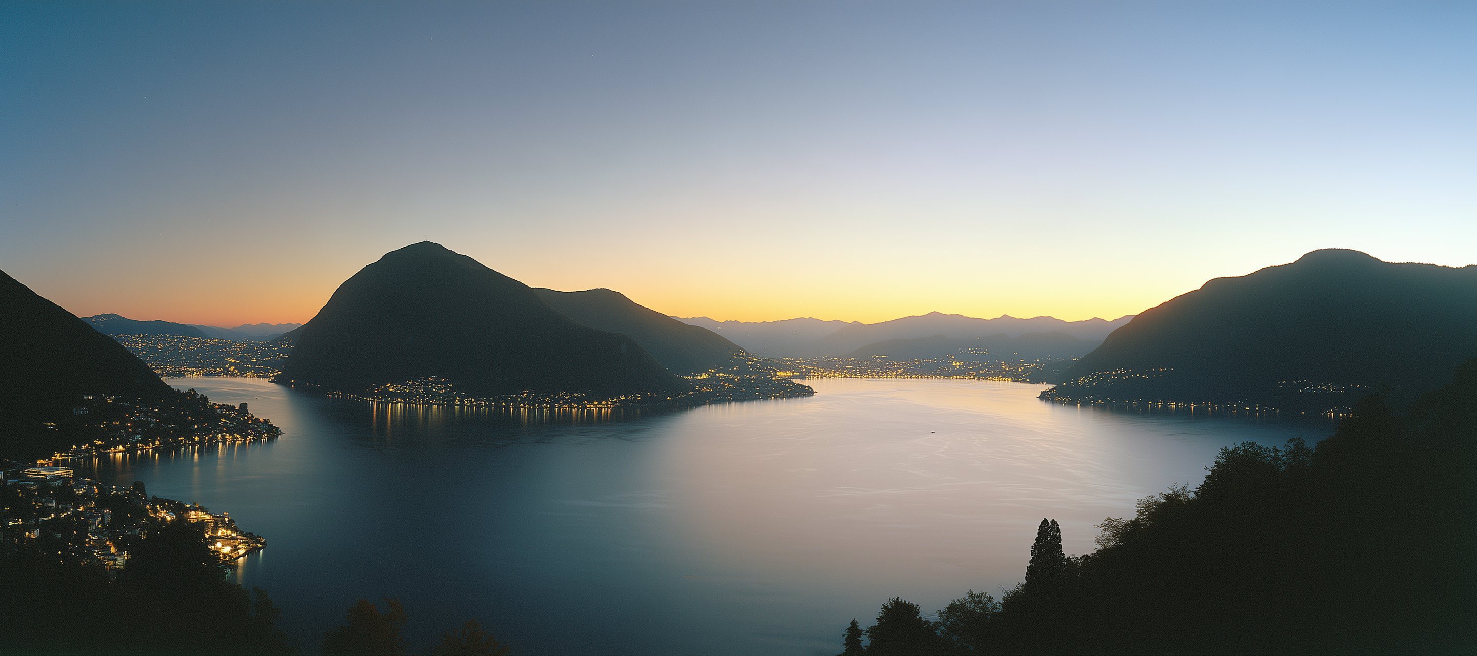 Lake Lugano at dusk, Monte San Salvatore and the lights of the town