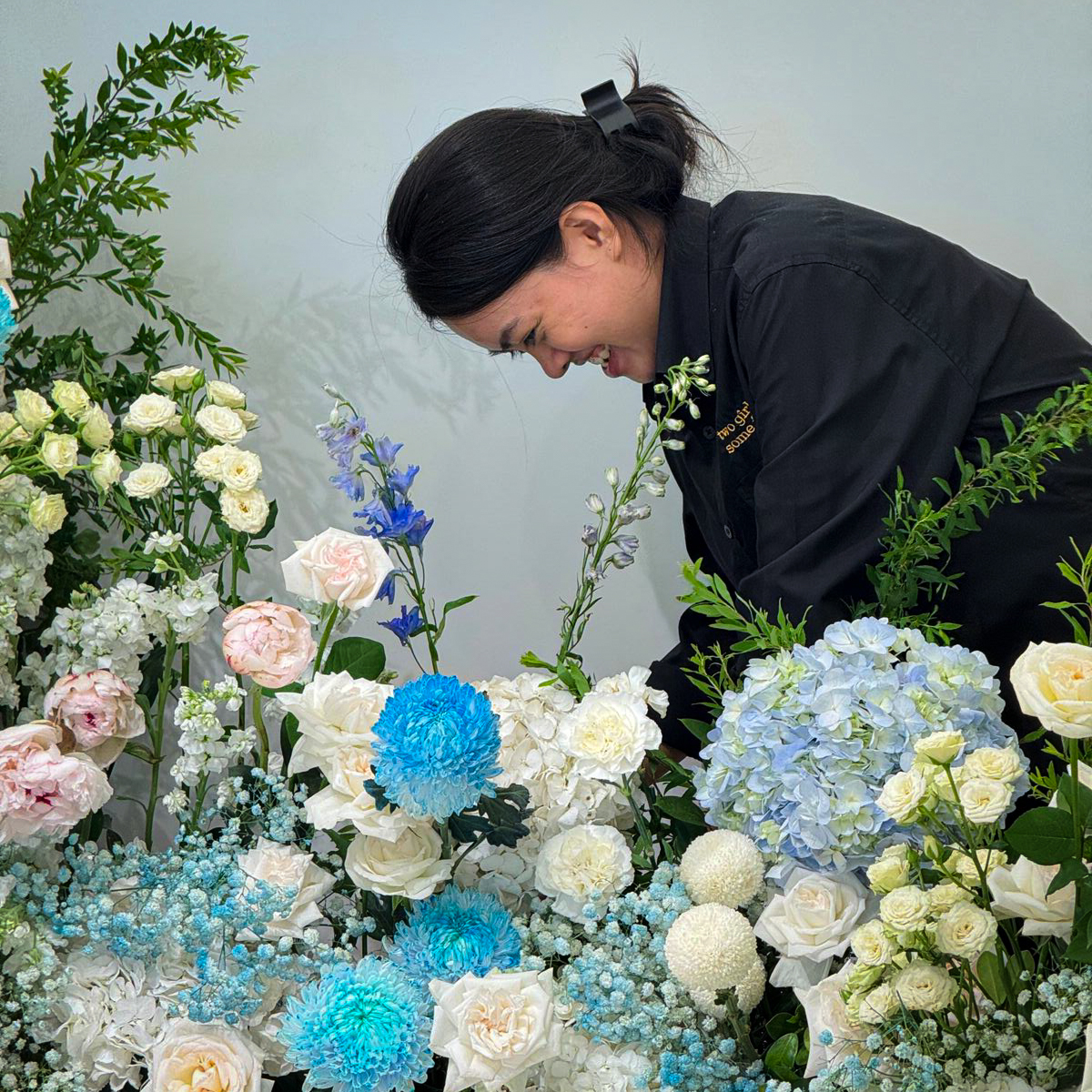 Florist arranging blue and white floral display