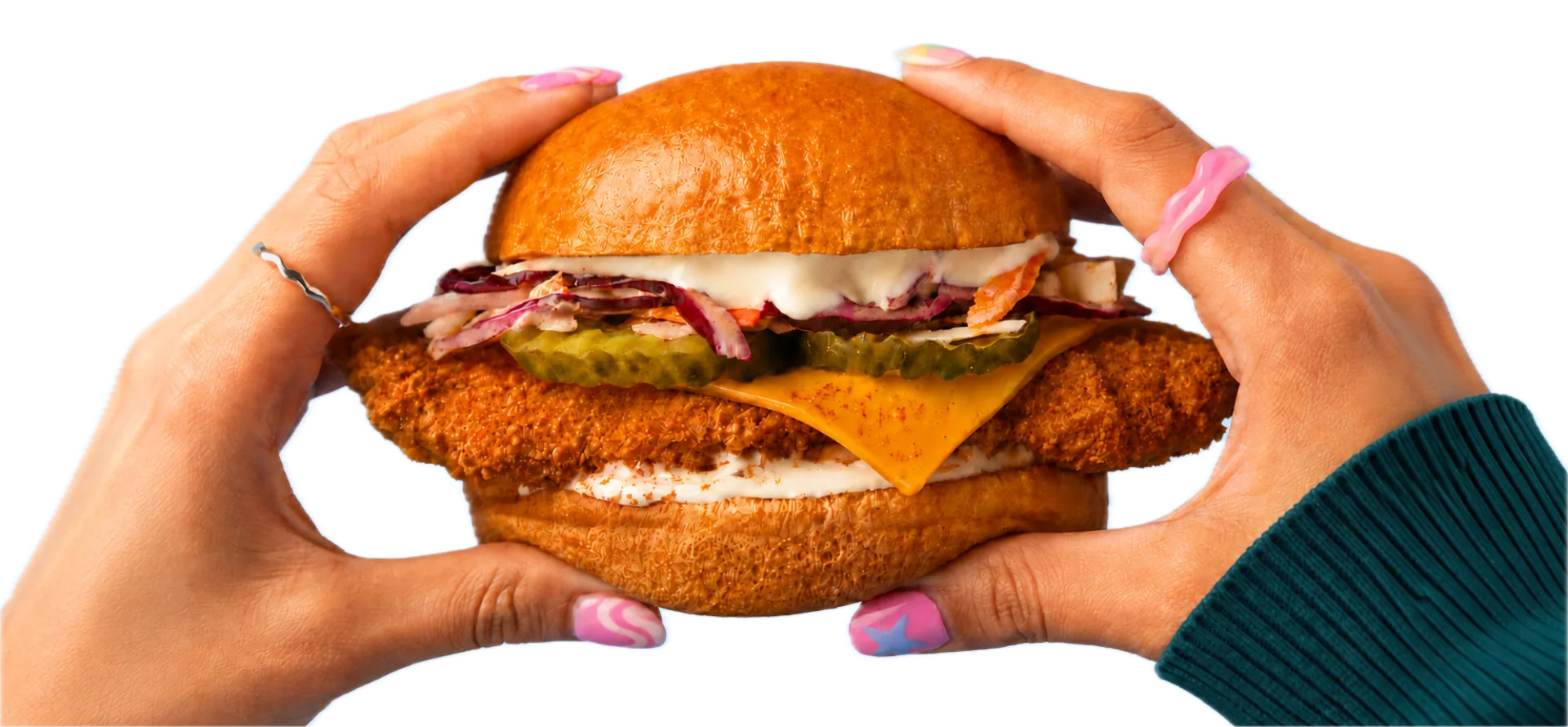 Crispy chicken burger held in two hands