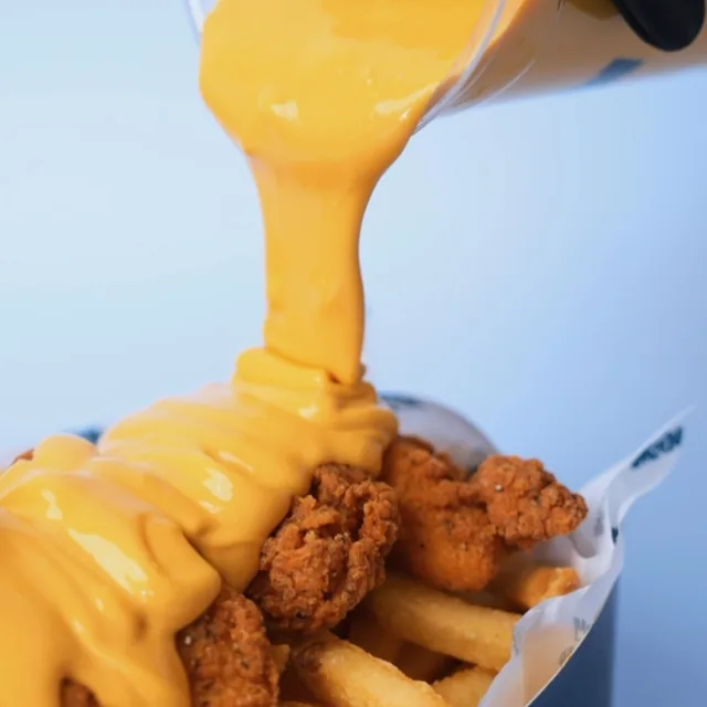 Cheese sauce over tenders and fries