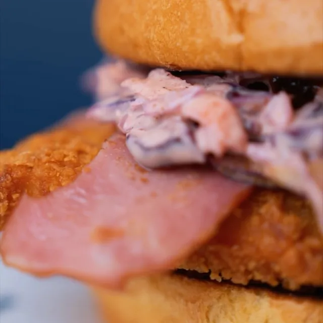 Chicken burger with turkey bacon and slaw