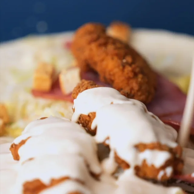 Ranch-drizzled tenders on salad