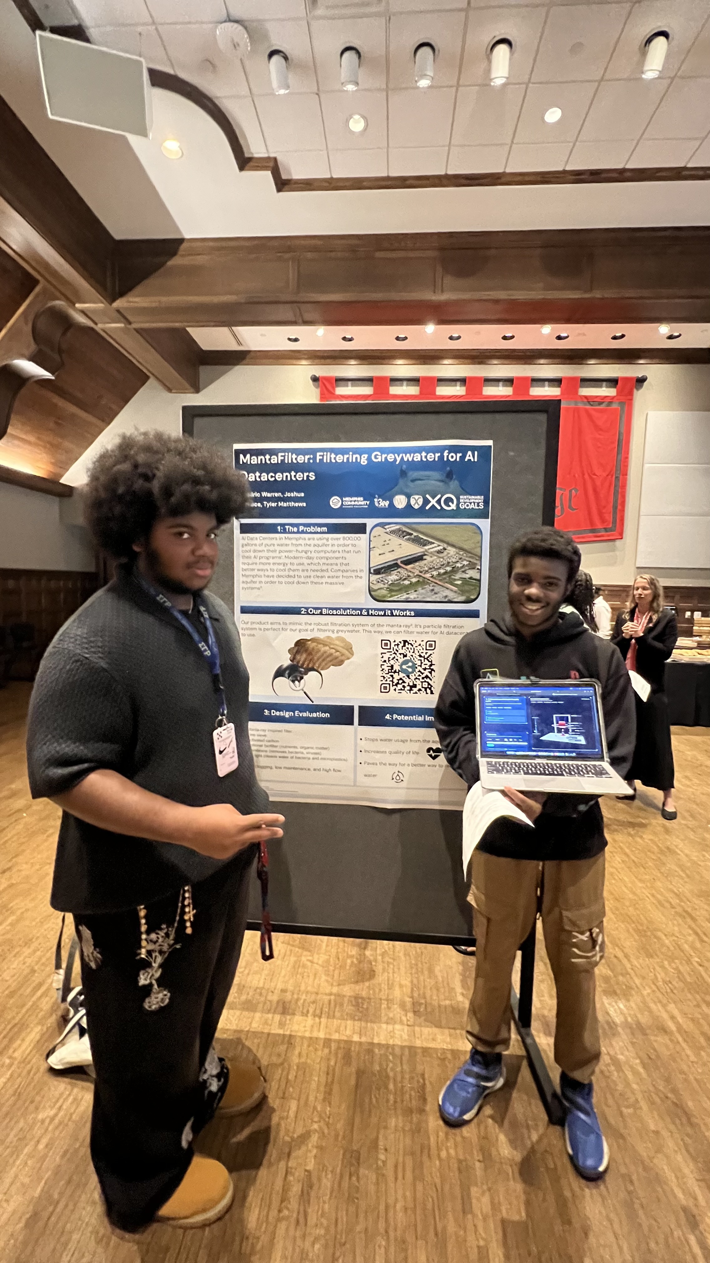 Two young scientists presenting their poster on the Manta Filter, a custom aquifer inspired by manta ray filtration