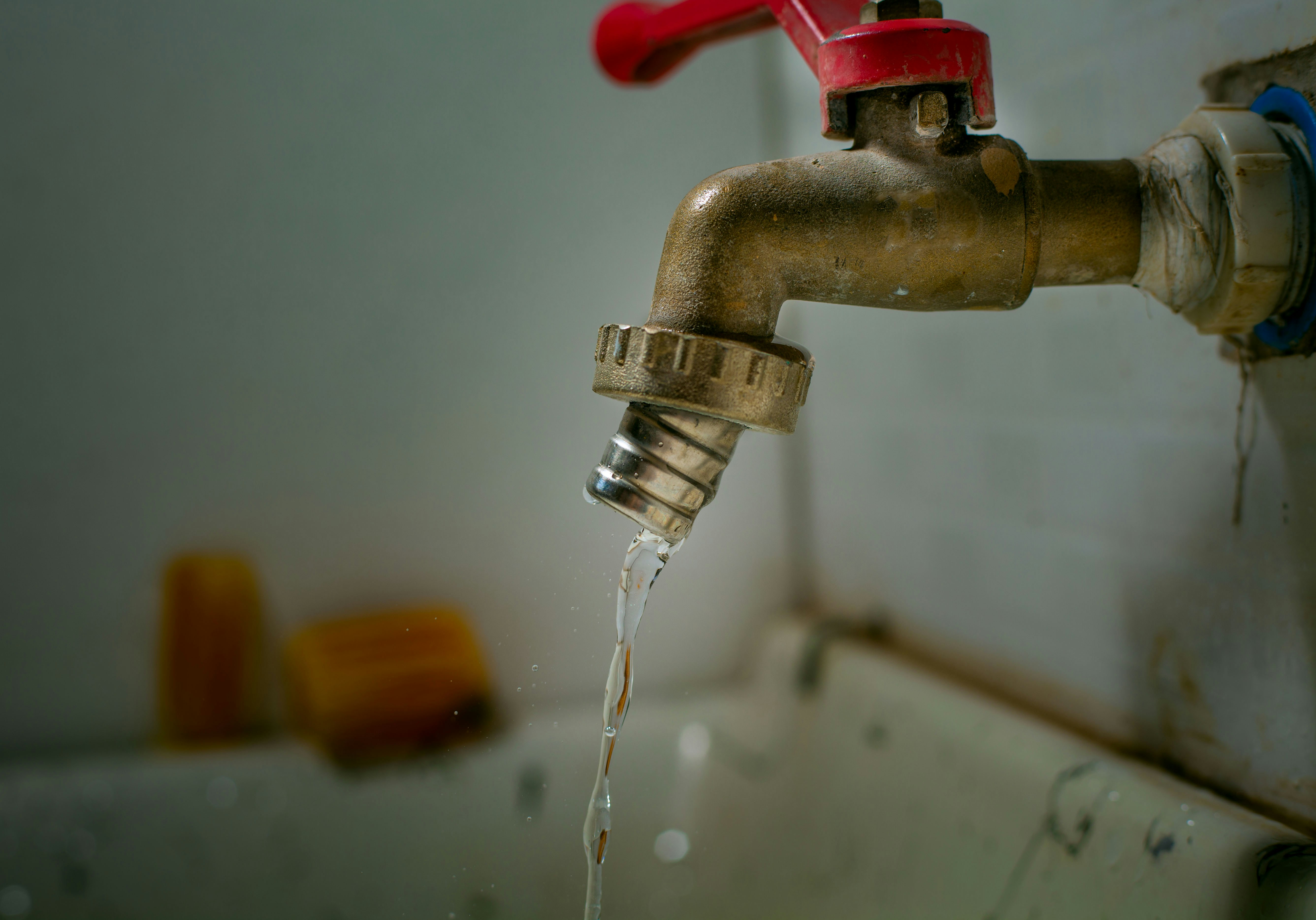 Modern kitchen faucet being installed by a licensed plumber.
