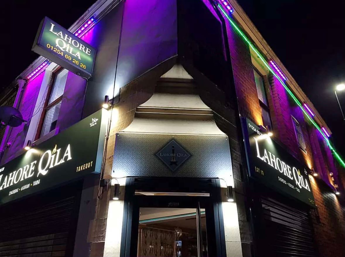 Lahore Qila restaurant shopfront in Blackburn at night