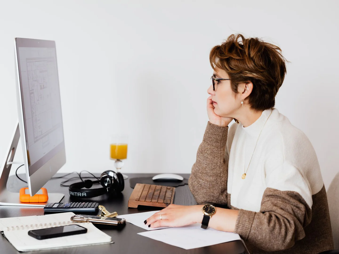 Architect reviewing a building plan at her workstation