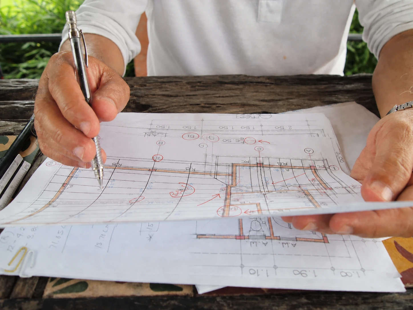 Reviewers marking corrections on a construction plan